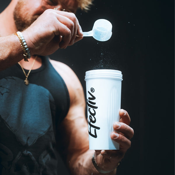 man pouring protein into protein shaker 