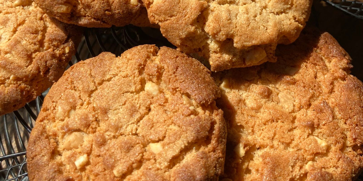 Golden crunchy peanut butter protein cookies on a wire cooling rack